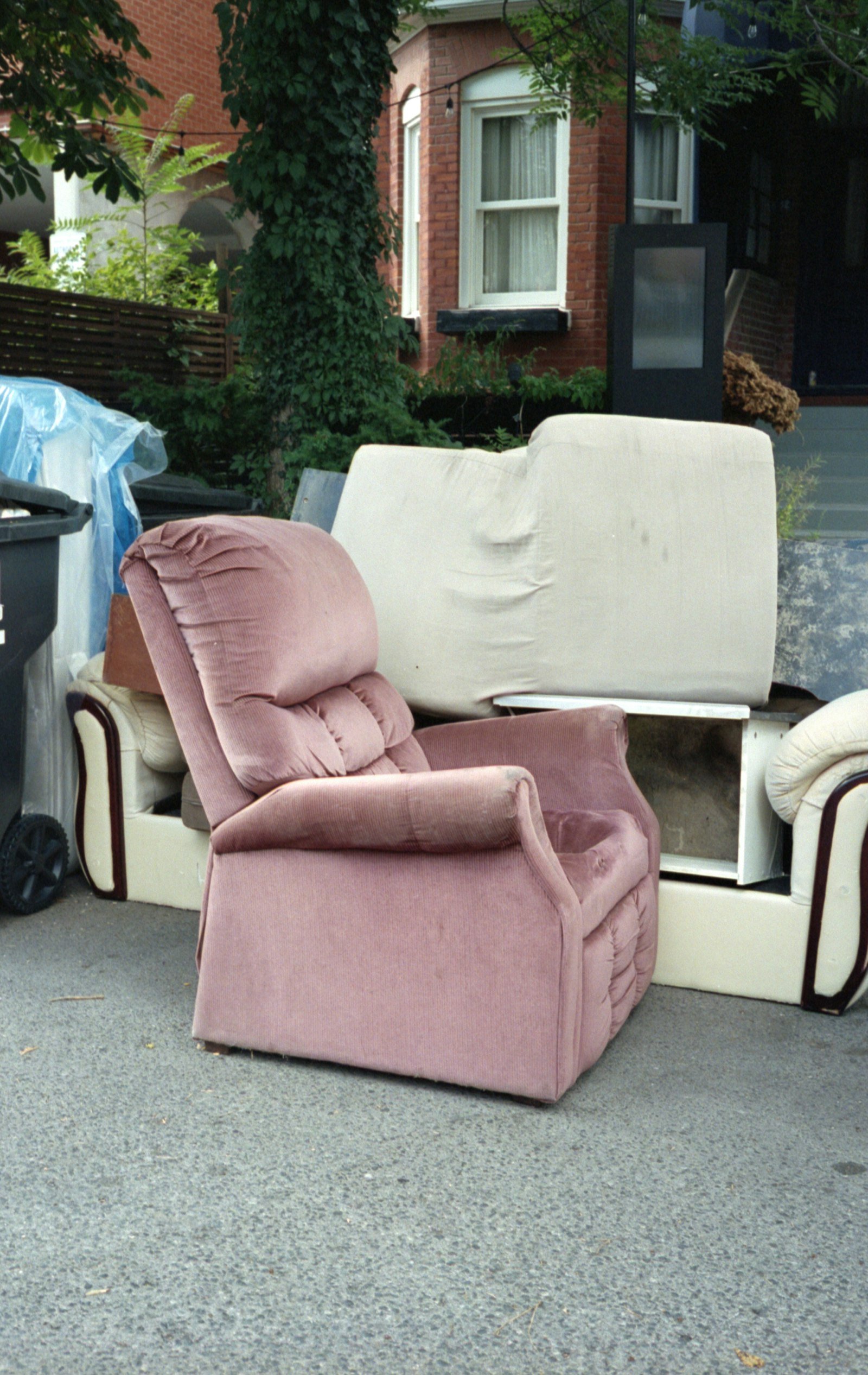 Old armchair and couches left at the curb