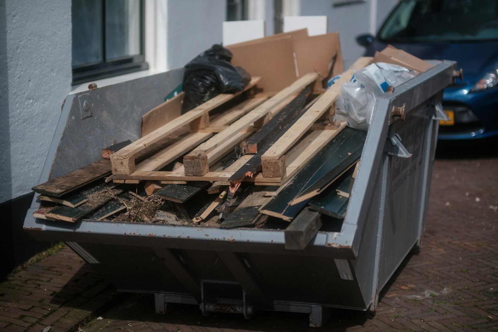 Open container filled with scrap lumber and pallets