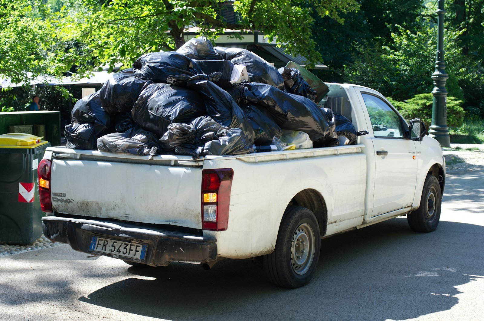 Pickup truck piled high with full trash bags
